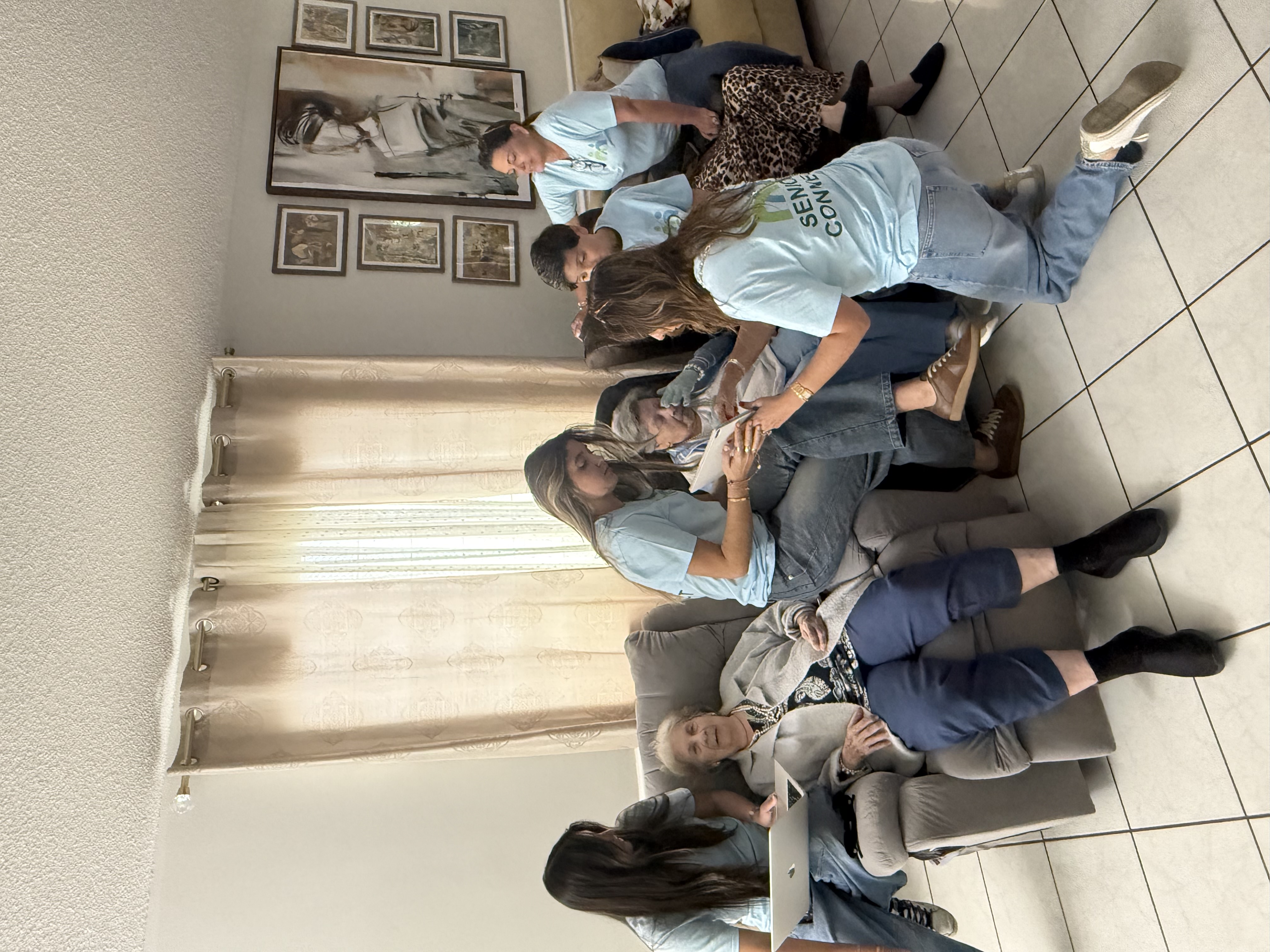Senior Connect volunteers helping seniors during a digital literacy visit